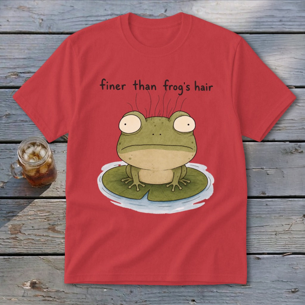 A red t-shirt displays an illustration of a green frog on a lily pad with text reading finer than frog's hair.