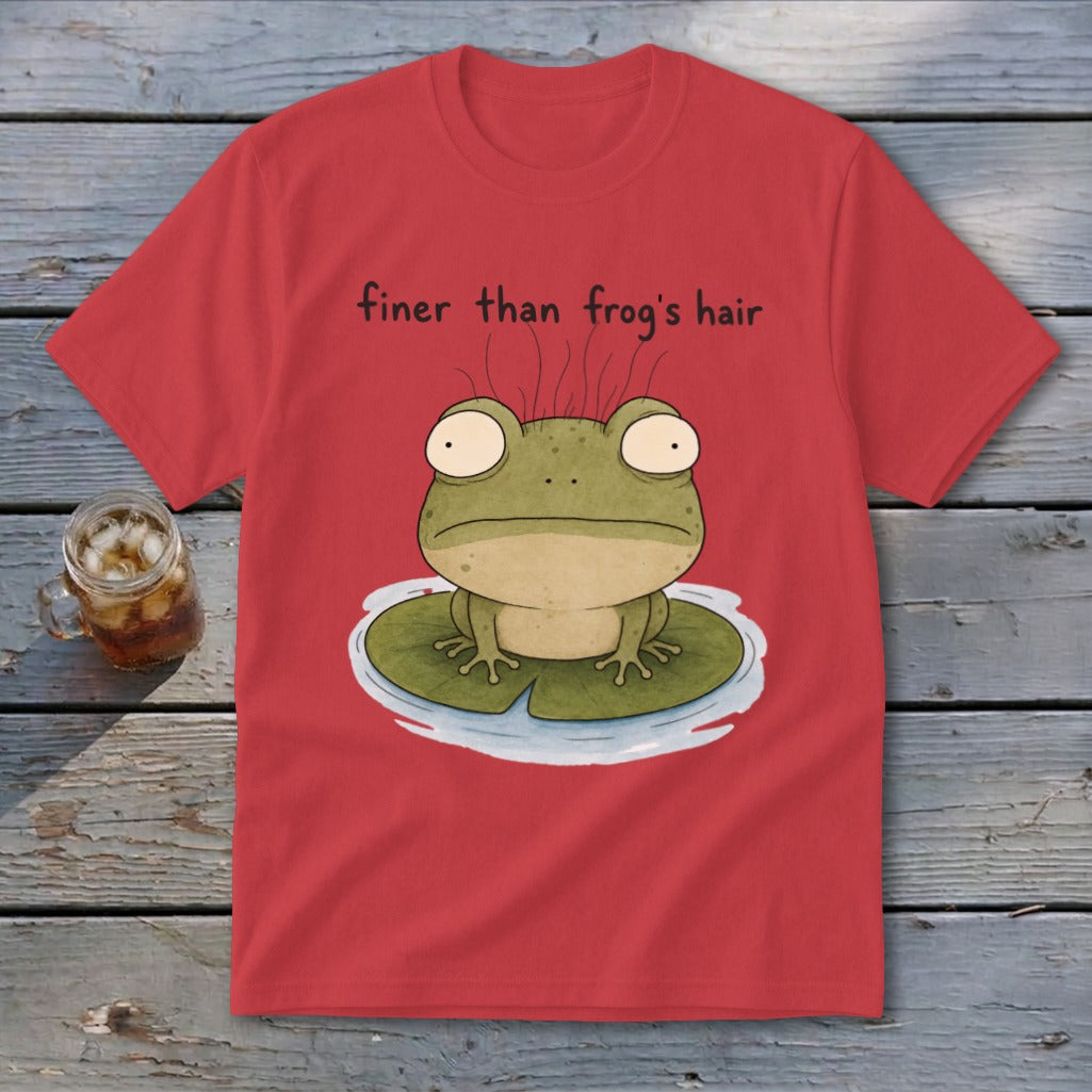 A red t-shirt displays an illustration of a green frog on a lily pad with text reading finer than frog's hair.