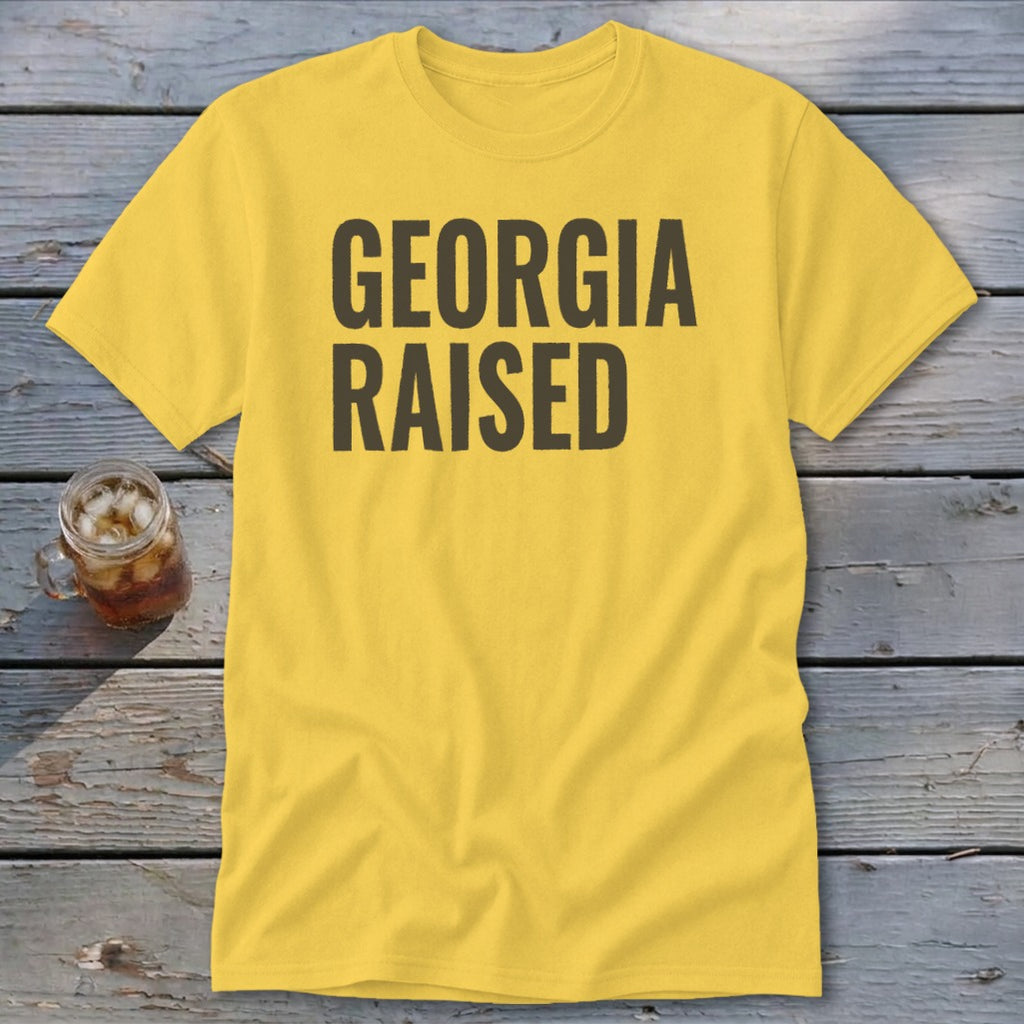 Yellow t-shirt with "GEORGIA RAISED" text in dark gray.