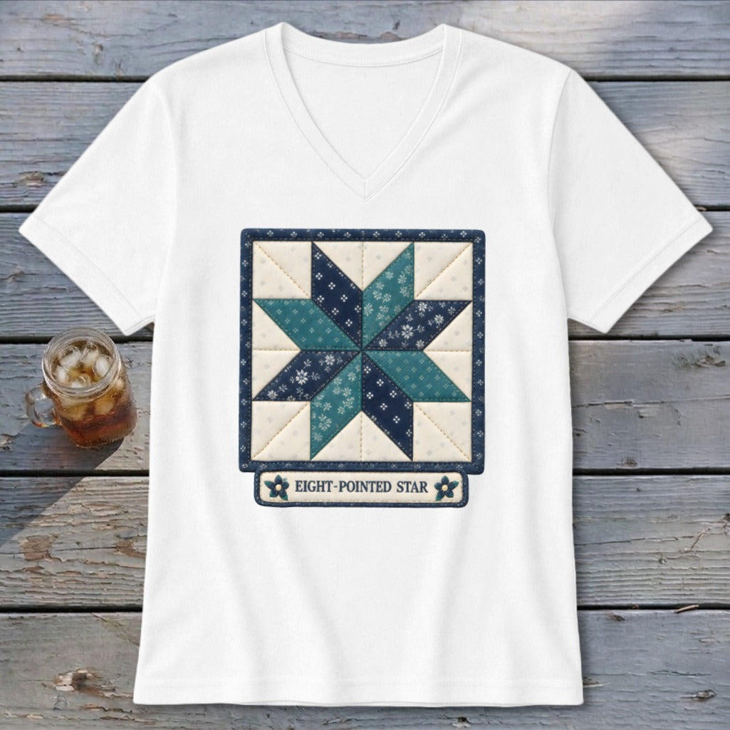 White t-shirt with a stitched quilt square featuring an eight-pointed star design.