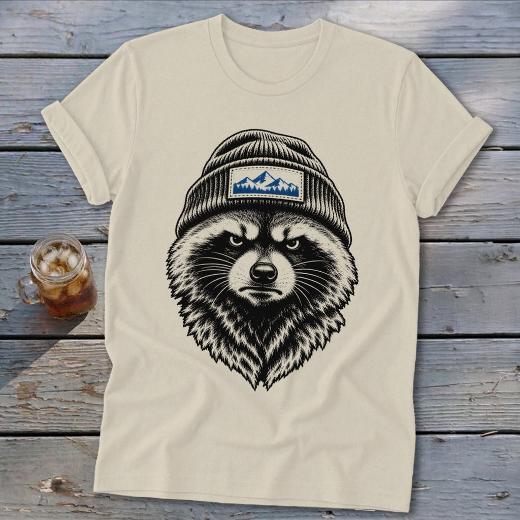 Cream t-shirt with black graphic of a raccoon wearing a beanie with a mountain patch.