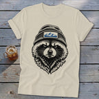 Cream t-shirt with black graphic of a raccoon wearing a beanie with a mountain patch.