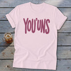 Pink t-shirt with burgundy "YOU'UNS" text.