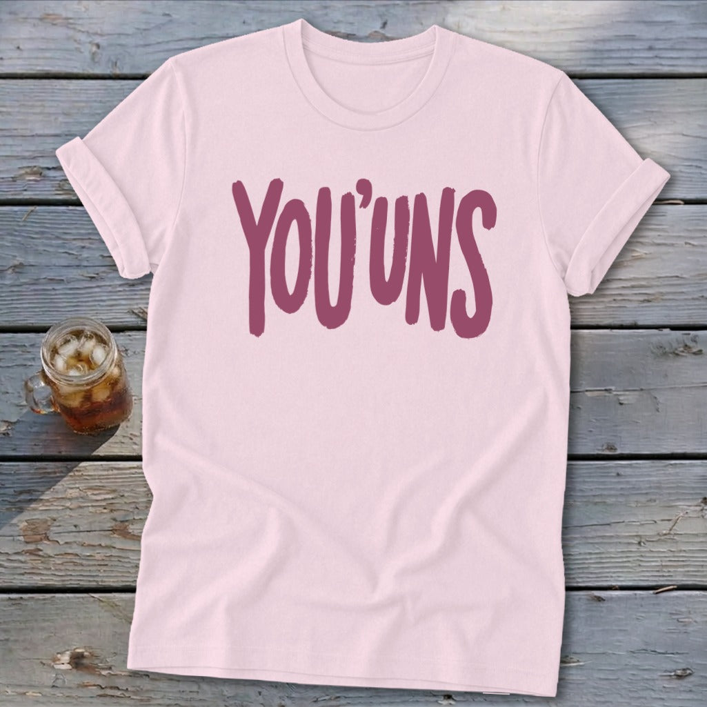 Pink t-shirt with burgundy "YOU'UNS" text.