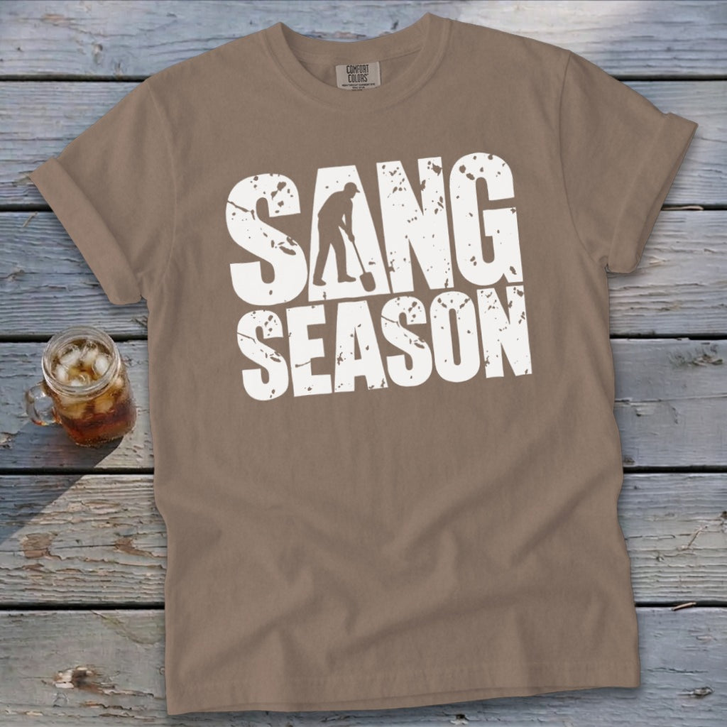 Brown t-shirt featuring distressed white text that reads SANG SEASON with a digger silhouette.