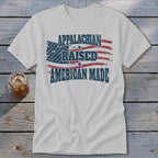 White t-shirt with distressed American flag graphic and text "Appalachian Raised American Made".