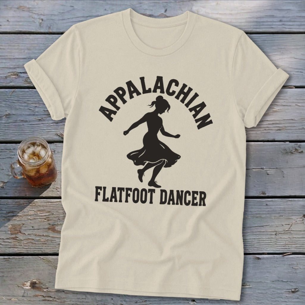 A cream-colored t-shirt featuring a black silhouette of a dancer with text reading "APPALACHIAN FLATFOOT DANCER."