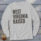 White long-sleeve shirt with "WEST VIRGINIA RAISED" text in dark gray.