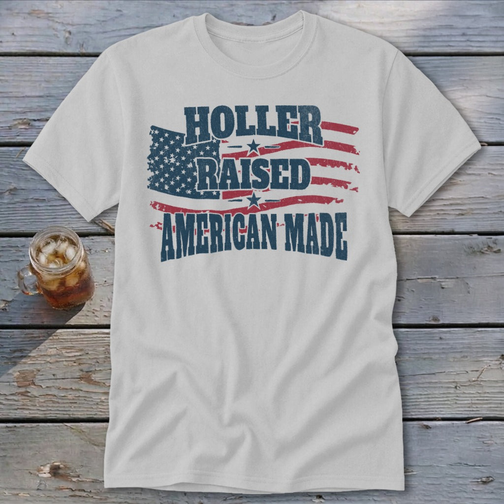 White t-shirt with "Holler Raised American Made" text and distressed American flag graphic.