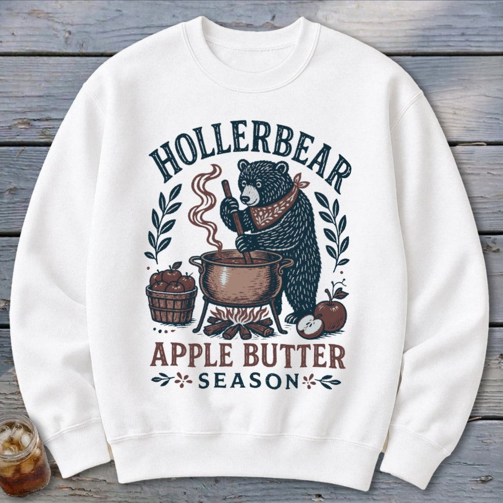 White sweatshirt with "Hollerbear Apple Butter Season" graphic of a bear stirring a pot.