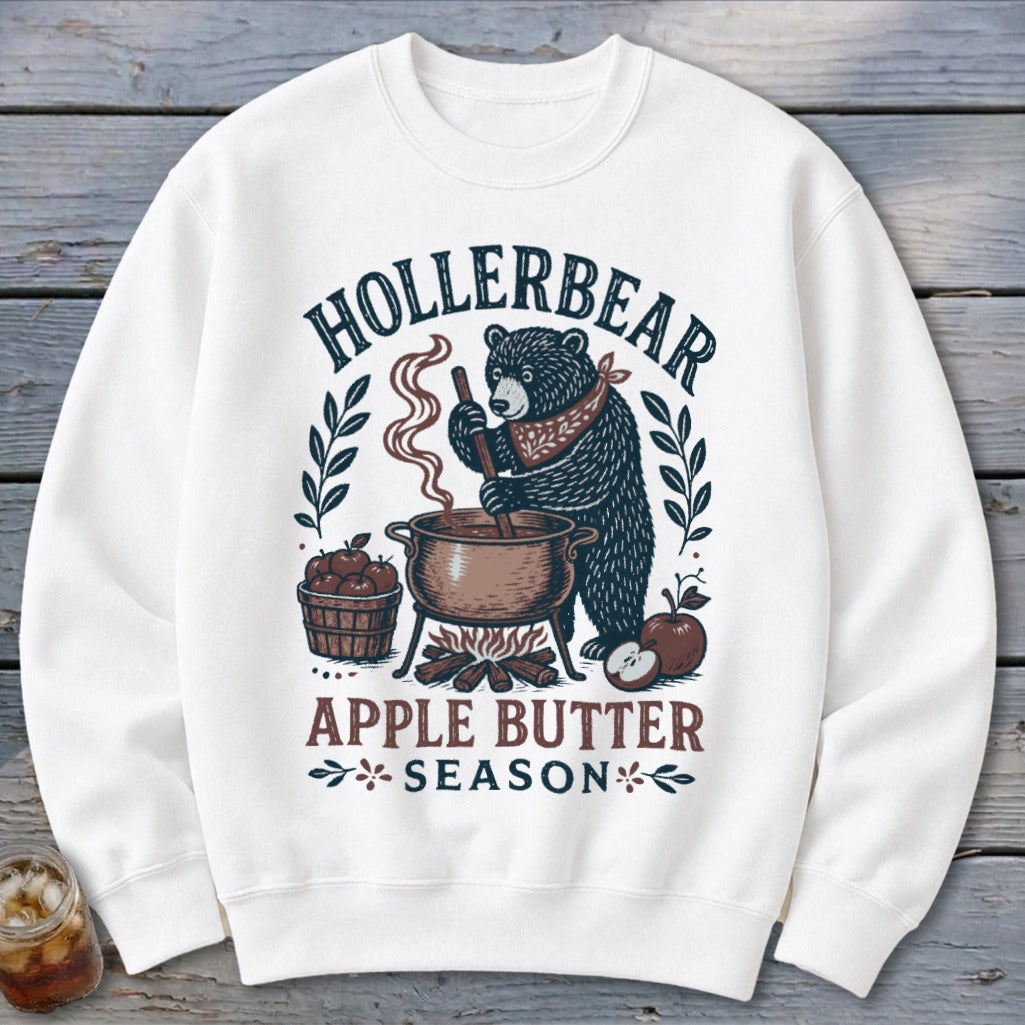 White sweatshirt with "Hollerbear Apple Butter Season" graphic of a bear stirring a pot.