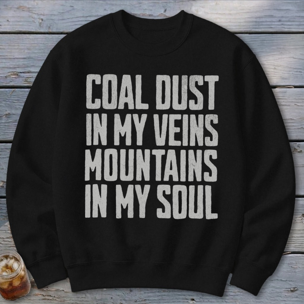 A black crewneck sweatshirt printed with the white distressed text, COAL DUST IN MY VEINS MOUNTAINS IN MY SOUL.