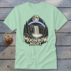 Light green t-shirt with a waterfall, moonbow, moon, and trees graphic, text reads "Moonbow Night".
