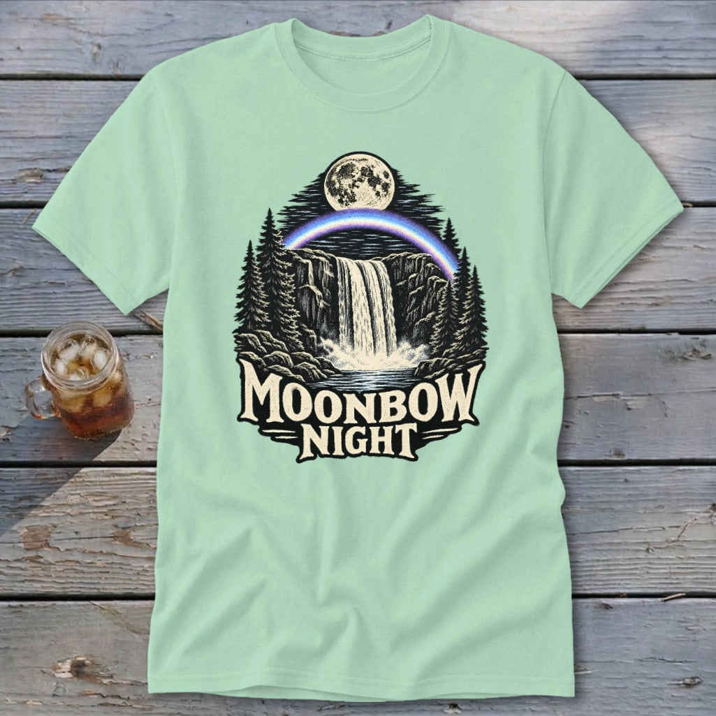 Light green t-shirt with a waterfall, moonbow, moon, and trees graphic, text reads "Moonbow Night".