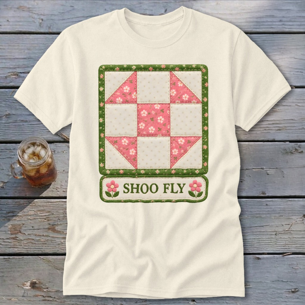 Cream t-shirt featuring a square quilt block design with pink flowers and "SHOO FLY" text.