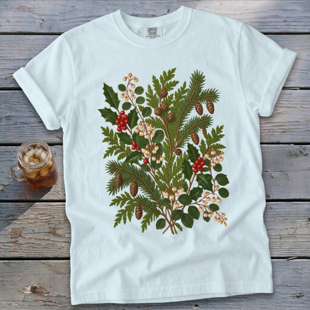 White t-shirt with a vintage botanical illustration of holly, pine, and berries.