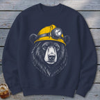 Black bear illustration wearing a yellow hard hat with a headlamp.
