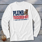 White long-sleeve shirt with "PLUMB TUCKED OUT" and rocking chair graphic.