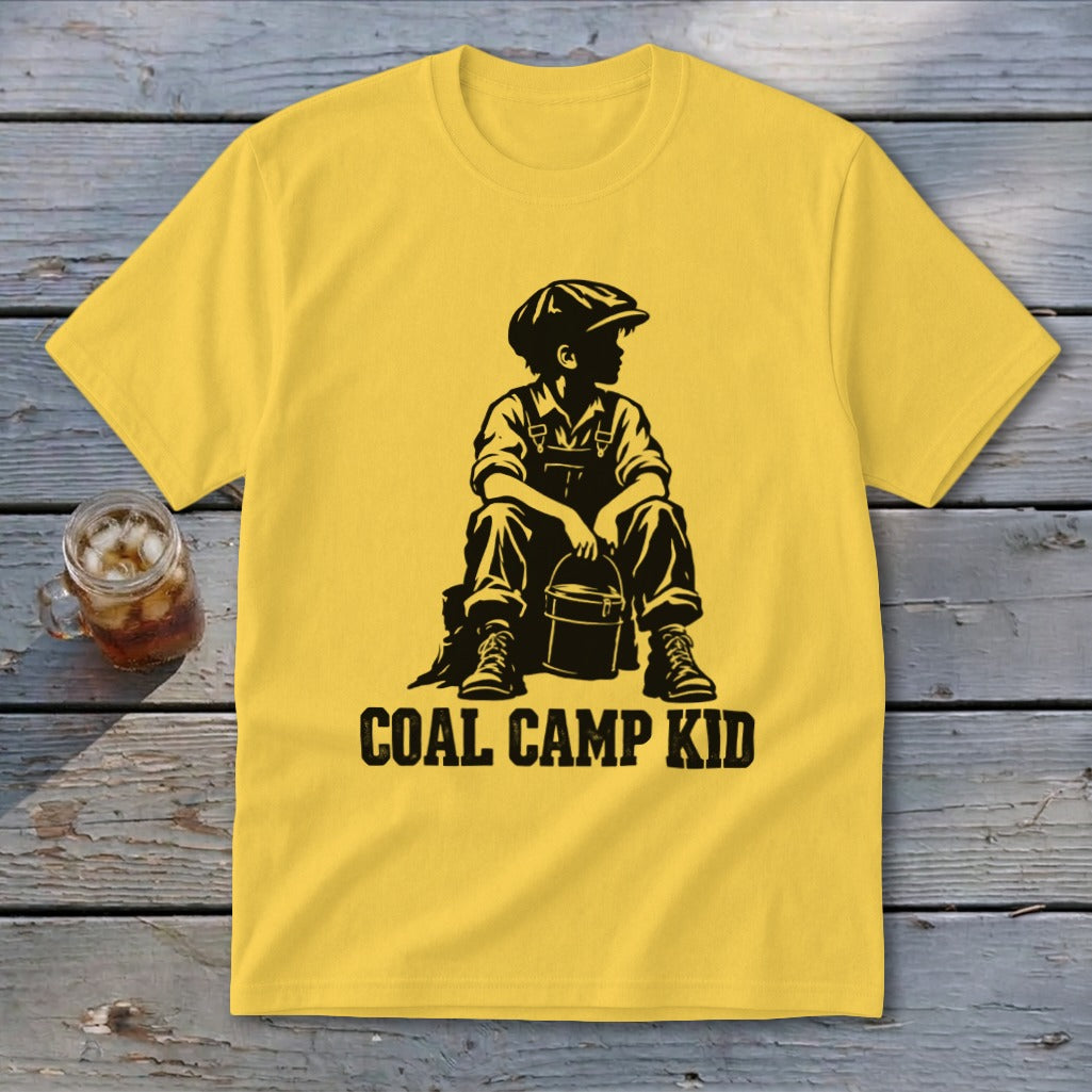 Yellow t-shirt with black graphic of a boy in overalls and cap holding a bucket, "COAL CAMP KID" text.