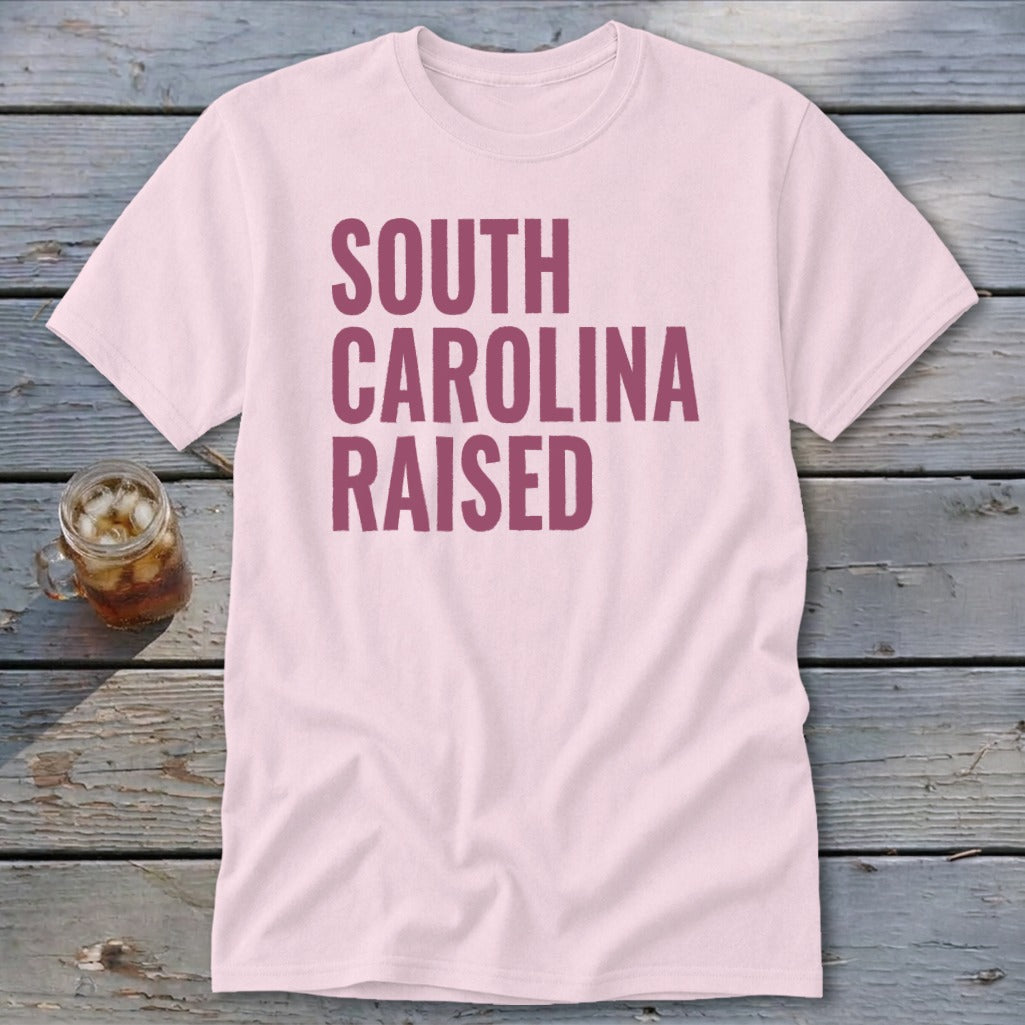 Pink t-shirt with "SOUTH CAROLINA RAISED" text in dark pink.