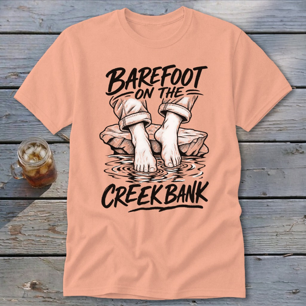 T-shirt with "Barefoot on the Creek Bank" text and drawing of bare feet in water.