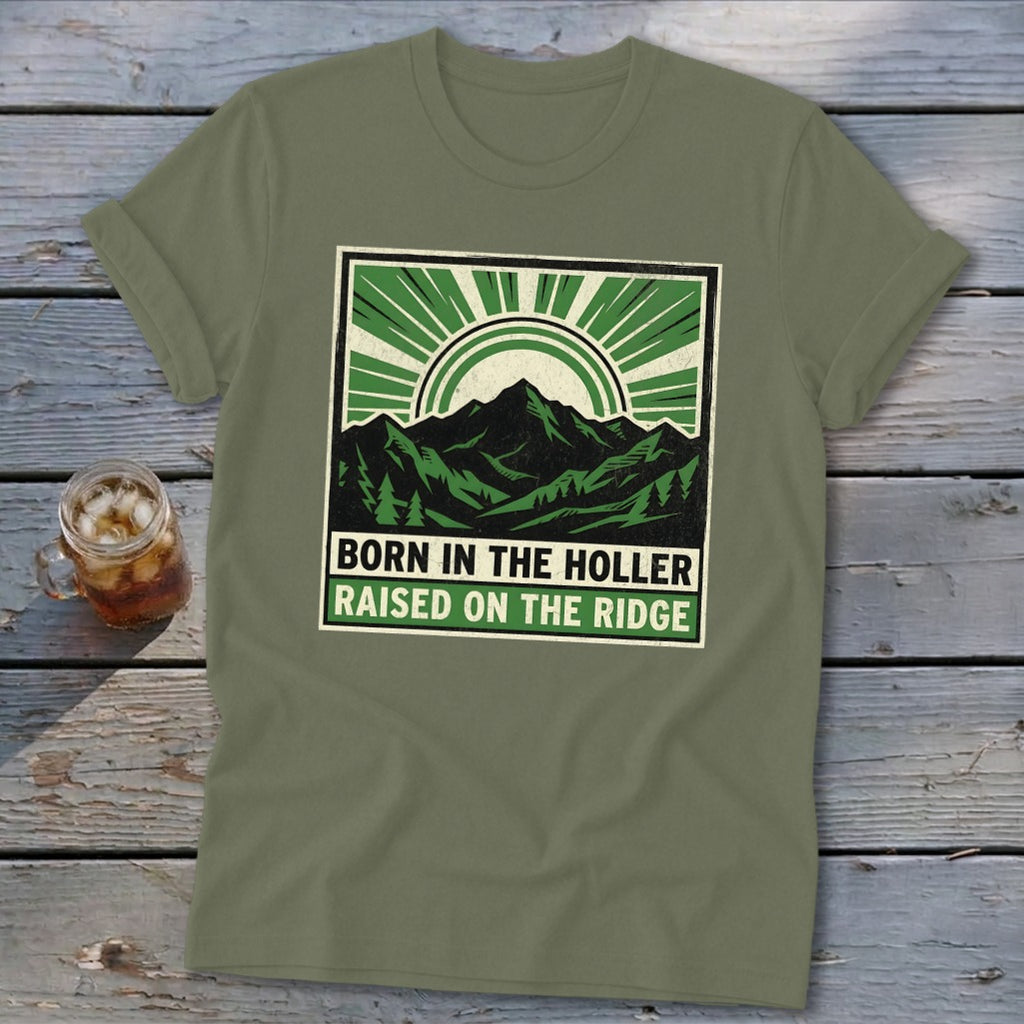 Olive green t-shirt featuring a mountain graphic and the text Born in the Holler, Raised on the Ridge.