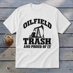 White t-shirt with black text and oil pump graphic: "OILFIELD TRASH AND PROUD OF IT".