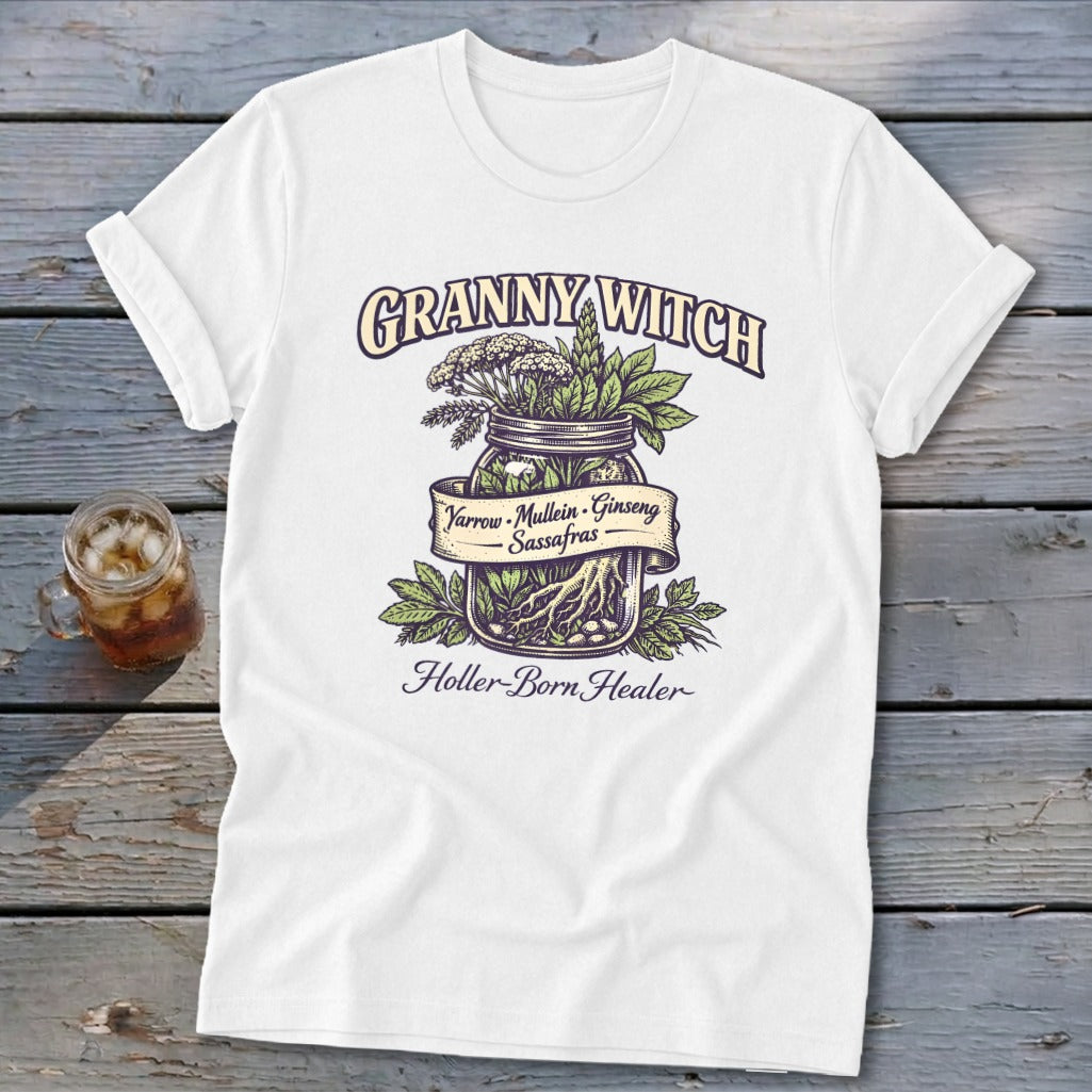 White t-shirt with "Granny Witch" and "Holler-Born Healer" text, featuring herbs in a jar.