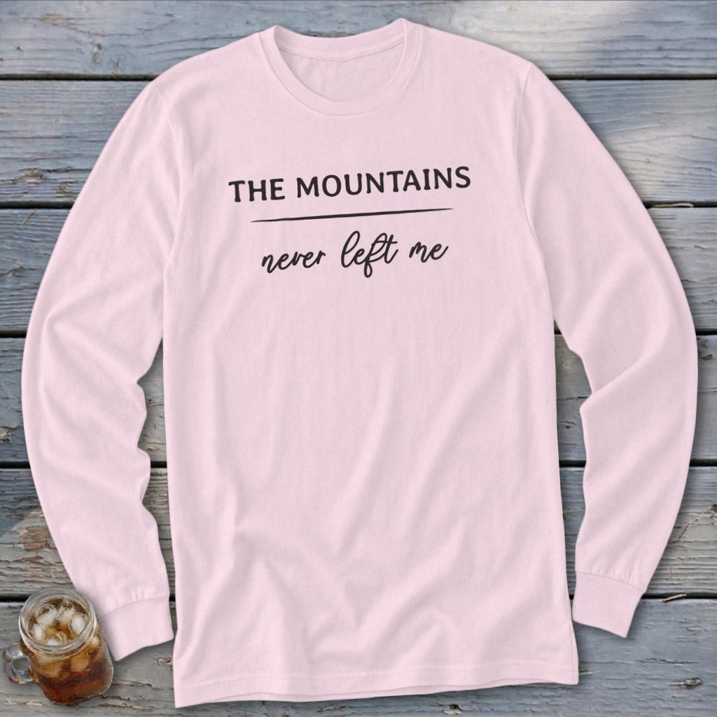 Light pink long-sleeve shirt with "The Mountains never left me" text.