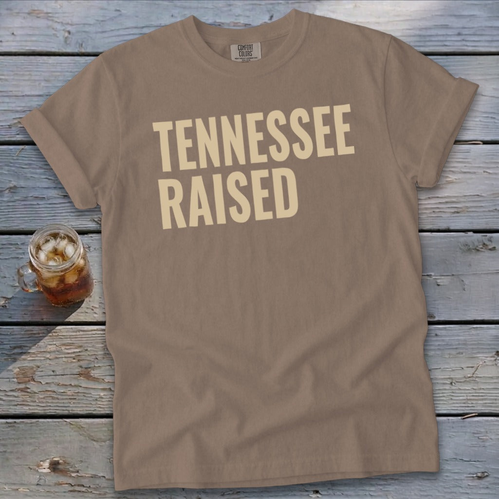 Tannin colored t-shirt with "Tennessee Raised" text in cream.