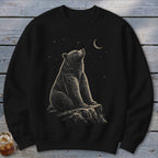 Black crewneck sweatshirt with a bear sitting on a rock under a crescent moon and stars.