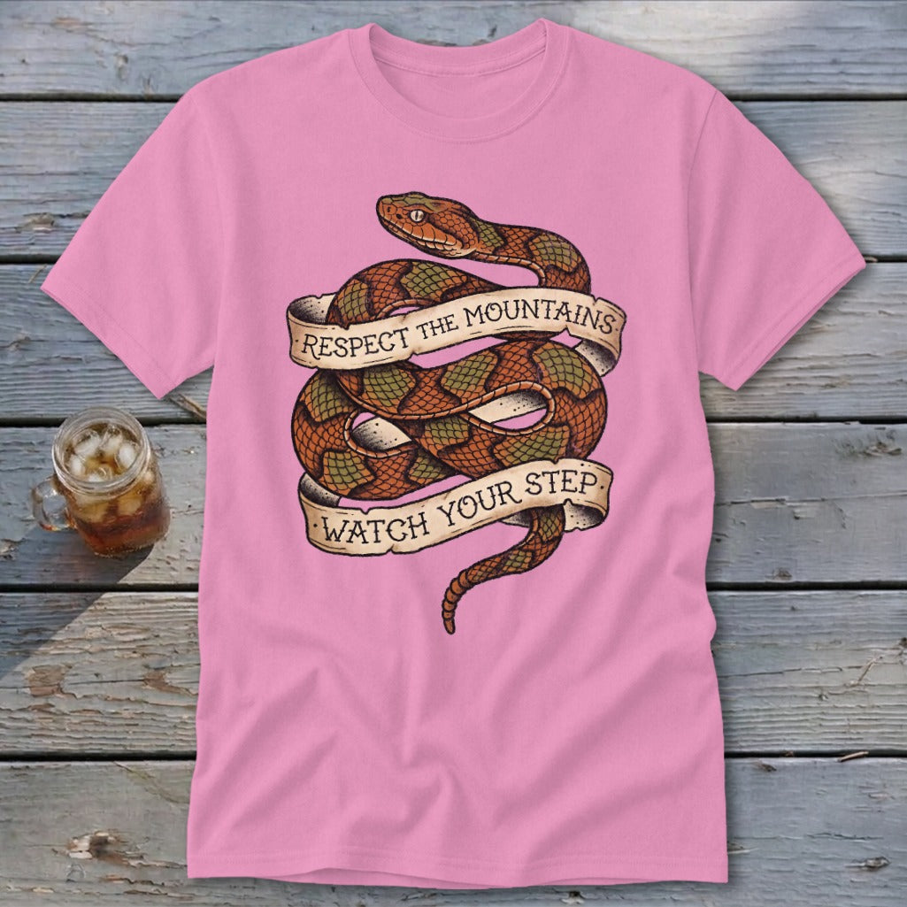 Pink t-shirt with coiled snake graphic and text: "Respect The Mountains Watch Your Step."
