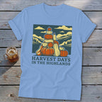 Light blue t-shirt with a vintage graphic of stacked pumpkins and hills, reading Harvest Days in the Highlands.