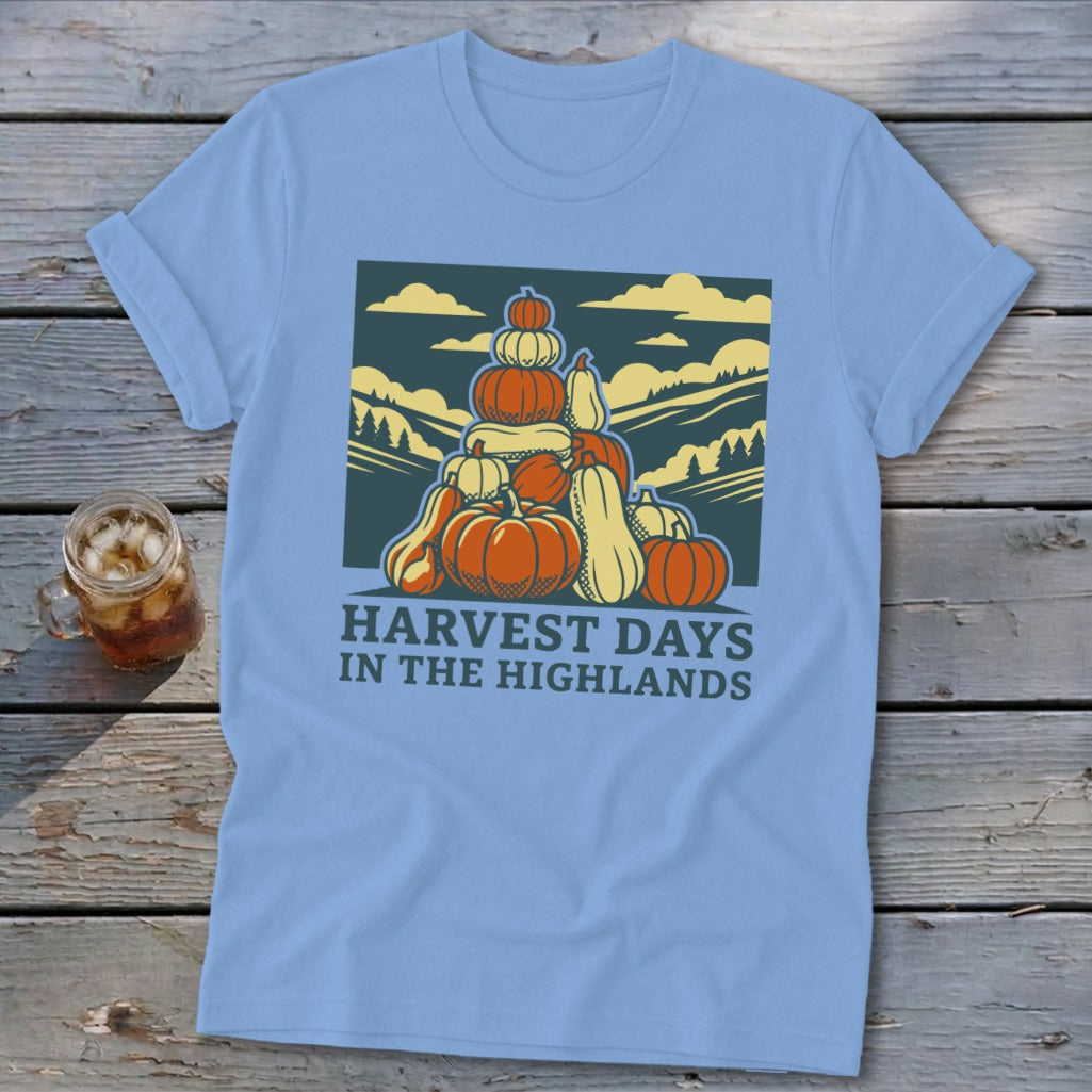 Light blue t-shirt with a vintage graphic of stacked pumpkins and hills, reading Harvest Days in the Highlands.