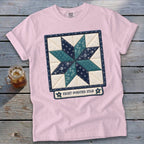 Pink t-shirt with an embroidered eight-pointed star quilt design and text.