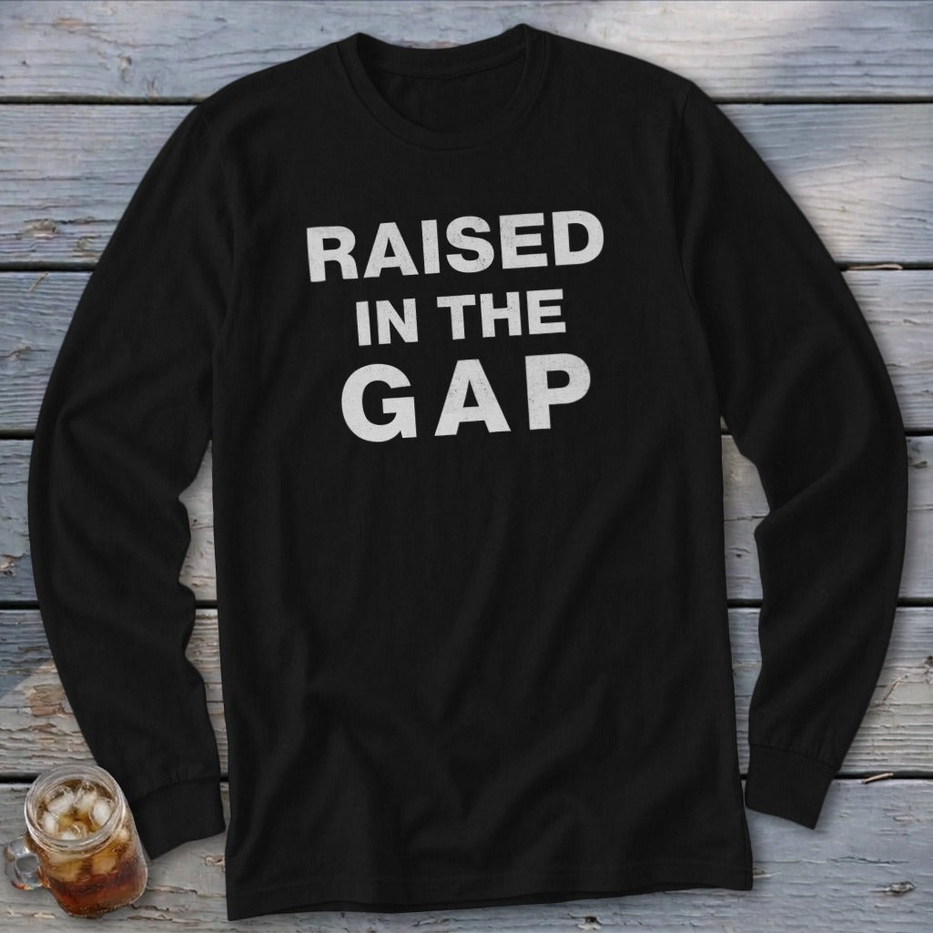 Black long-sleeve shirt with white text reading "RAISED IN THE GAP".