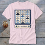 Pink t-shirt with a "Flying Geese" quilt design and blue floral accents.