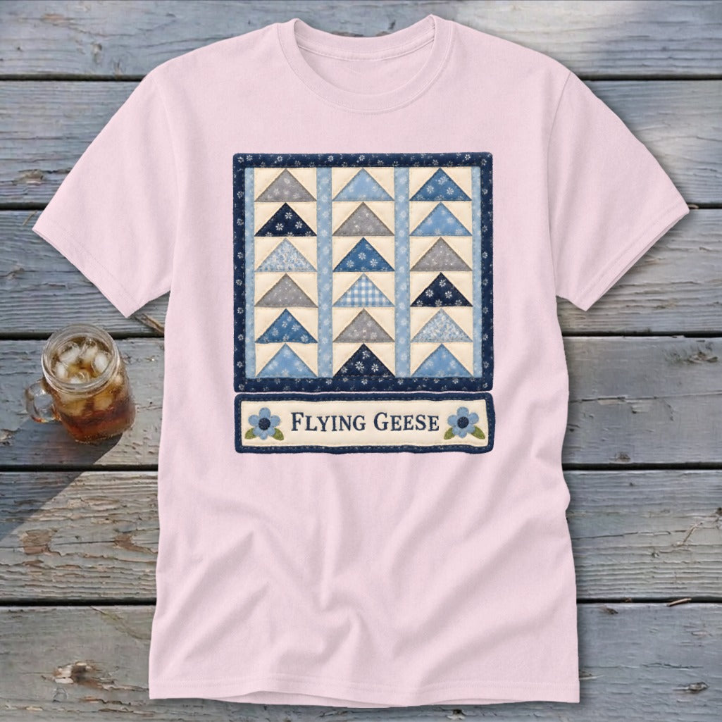 Pink t-shirt with a "Flying Geese" quilt design and blue floral accents.