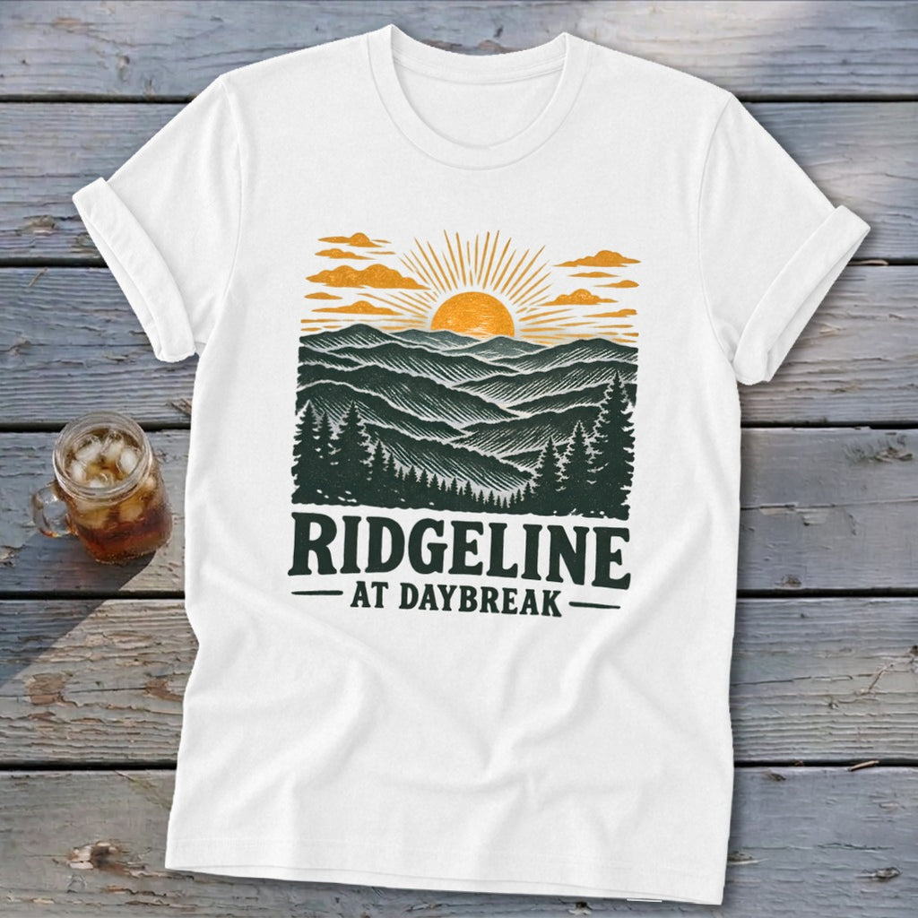 White t-shirt with "RIDGELINE AT DAYBREAK" and mountain sunset graphic.