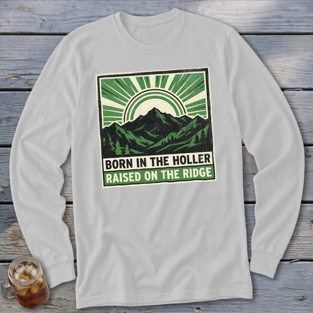 Light gray long-sleeve t-shirt with a green mountain graphic and text reading Born in the Holler Raised on the Ridge.