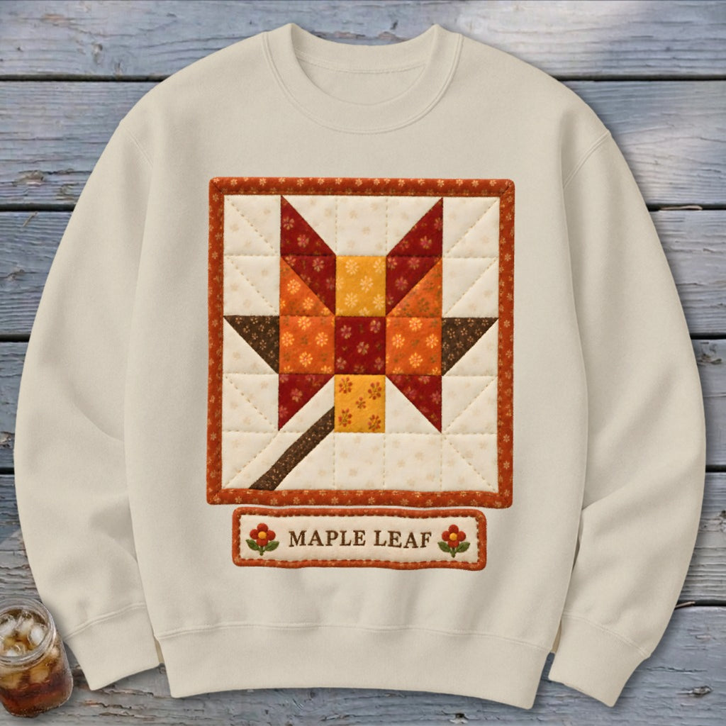 Cream sweatshirt with a quilted maple leaf design and "Maple Leaf" text.
