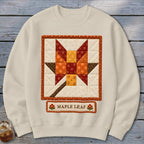 Cream sweatshirt with a quilted maple leaf design and "Maple Leaf" text.