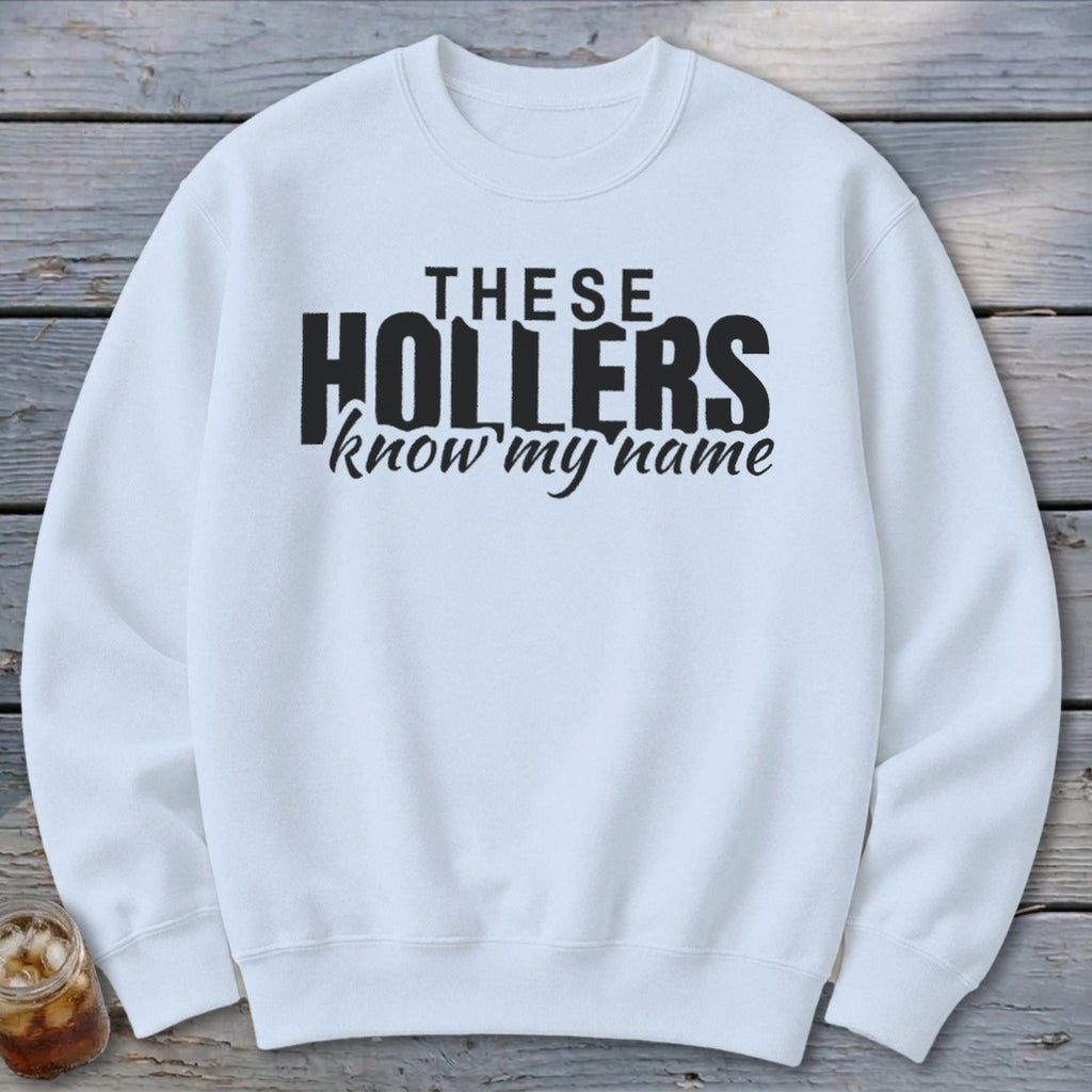 White sweatshirt with black text that reads "THESE HOLLERS know my name".