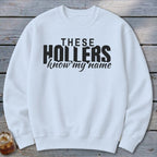 White sweatshirt with black text that reads "THESE HOLLERS know my name".