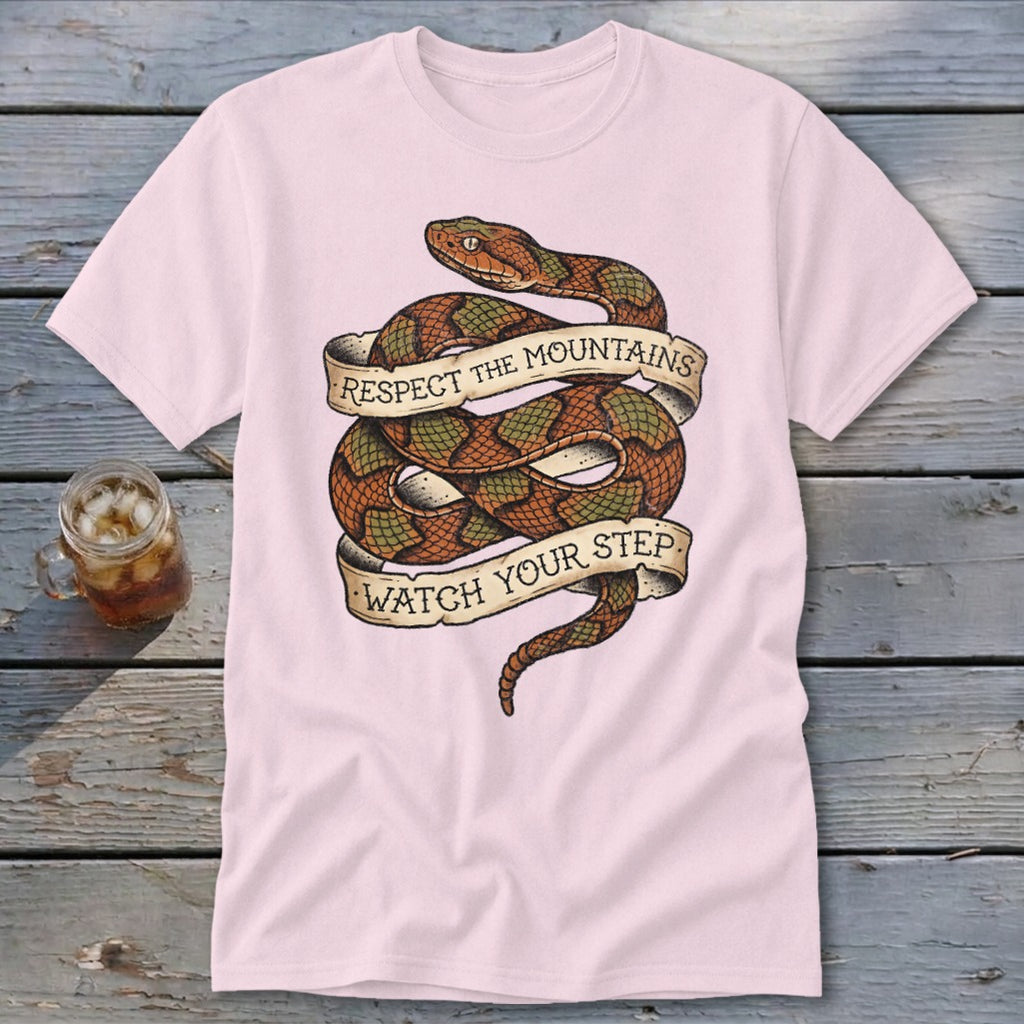 Pink t-shirt with coiled snake graphic and text "Respect the mountains watch your step."