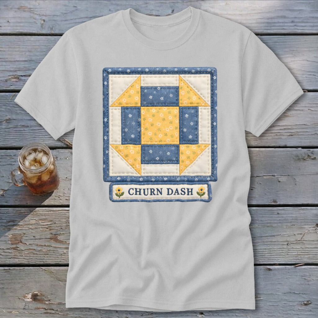 White t-shirt featuring a blue and yellow churn dash quilt block with "CHURN DASH" text.