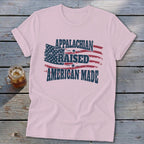 Pink t-shirt with distressed American flag graphic and text "APPALACHIAN RAISED AMERICAN MADE".