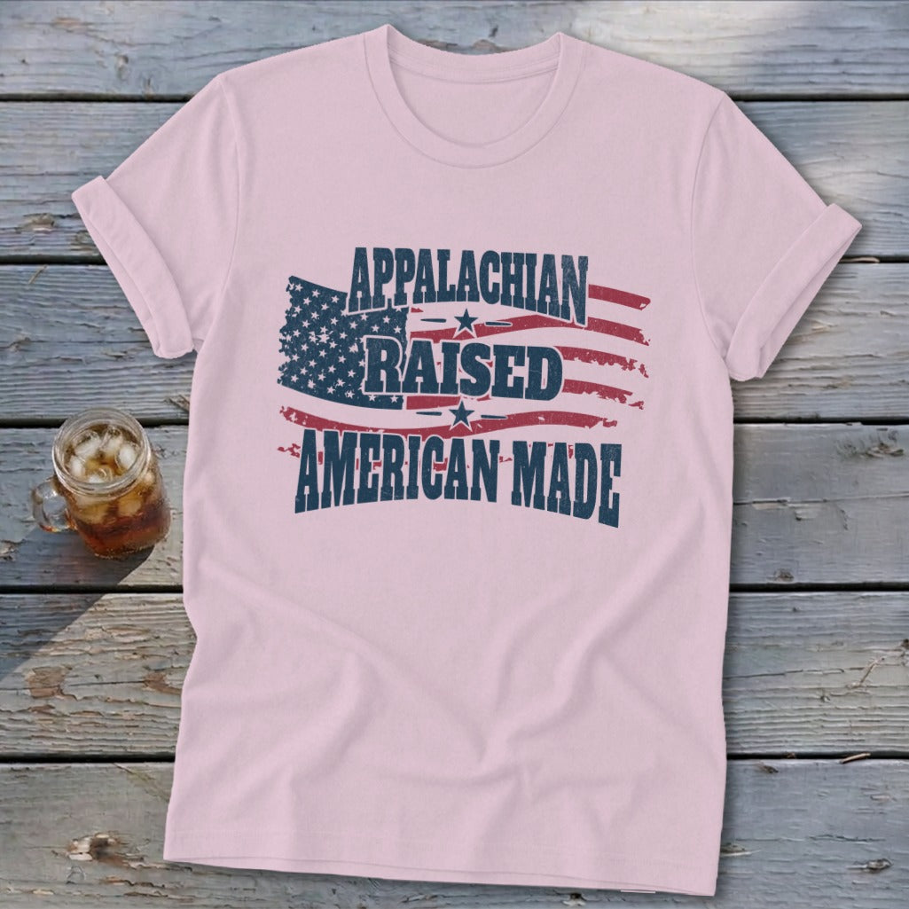 Pink t-shirt with distressed American flag graphic and text "APPALACHIAN RAISED AMERICAN MADE".