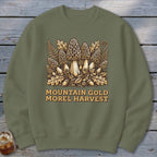 Olive green sweatshirt with a "Mountain Gold Morel Harvest" graphic of morel mushrooms.