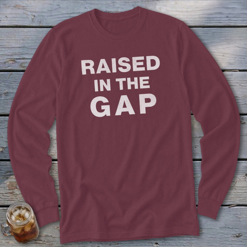 Maroon long-sleeve t-shirt with white text "RAISED IN THE GAP"
